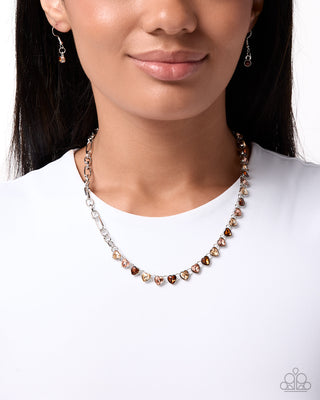 Sincere Shimmer silver necklace with peach champagne and topaz heart gems modeled