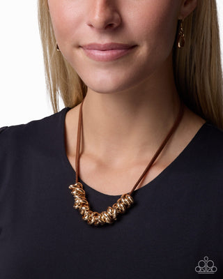 Woven Wheelhouse gold intertwined ring necklace with brown suede modeled